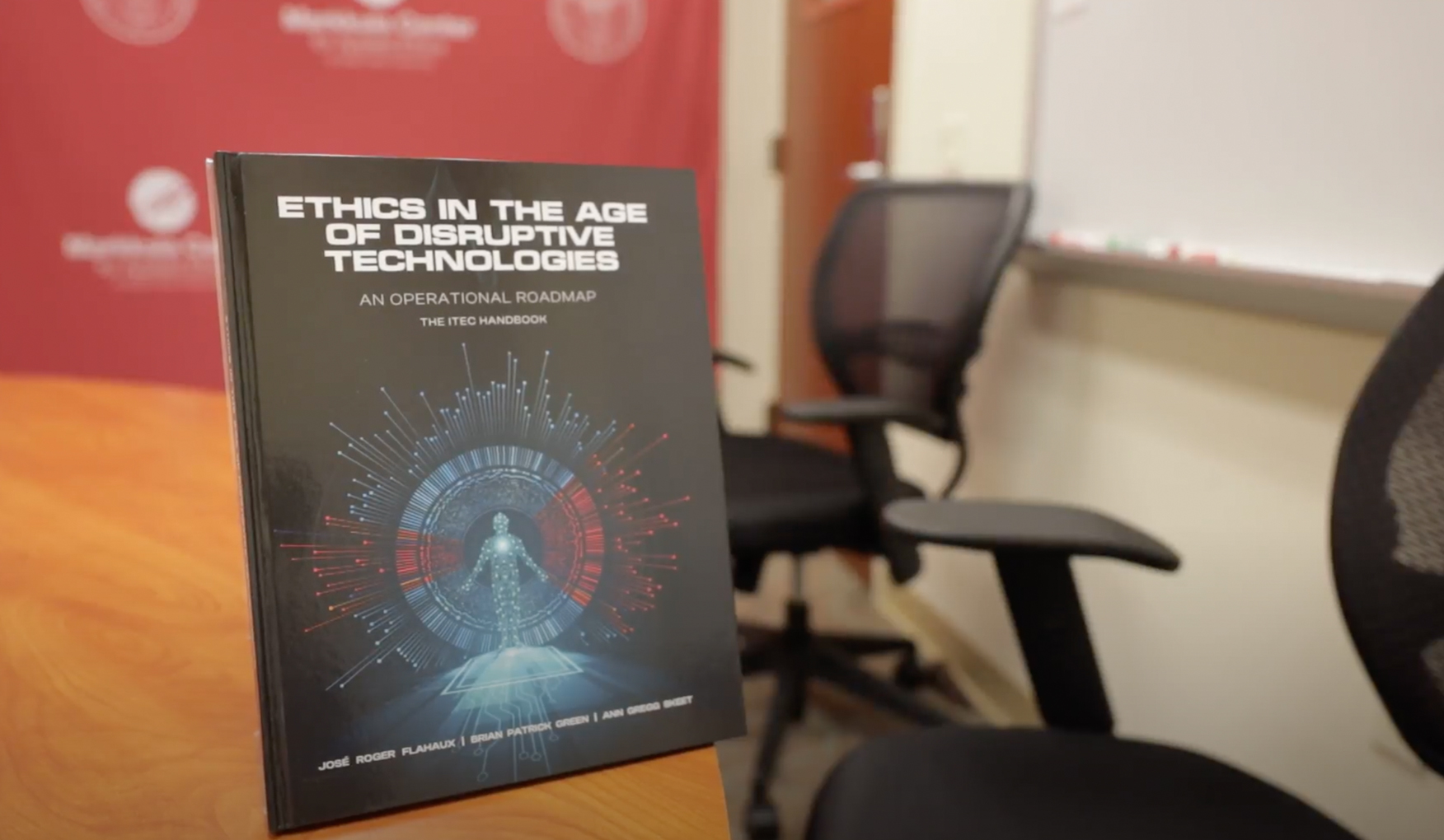 A book titled 'Ethics in the Age of Disruptive Technologies: An Operational Roadmap' by Jose Ruben Ferrete and Luis Gerardo Cabrera is standing upright on a table.